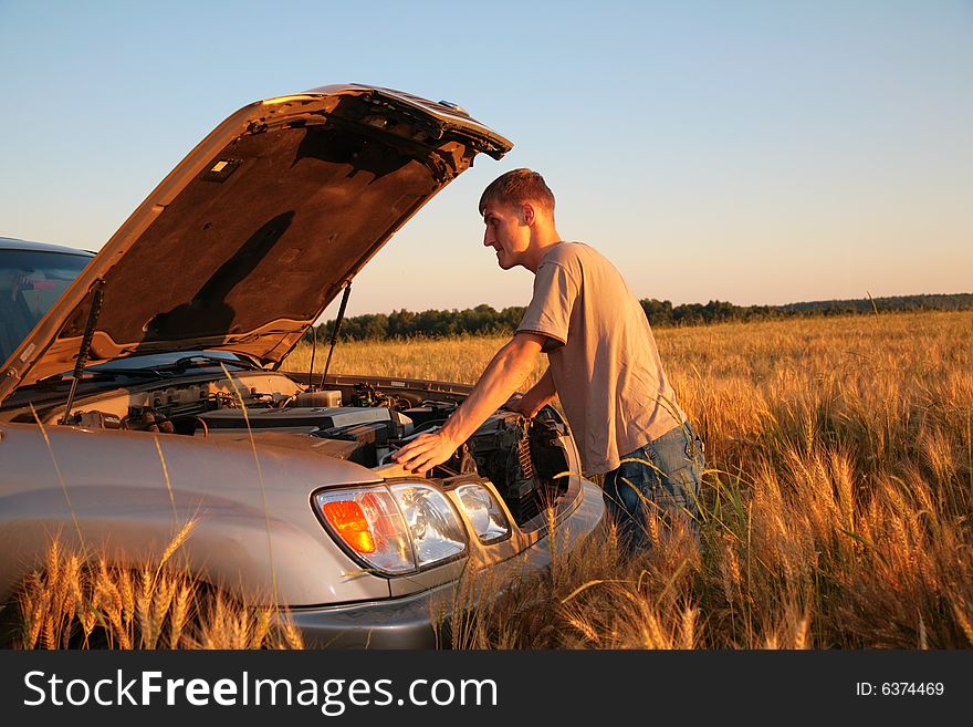 Man At Offroad Car With  Lifted Cowl