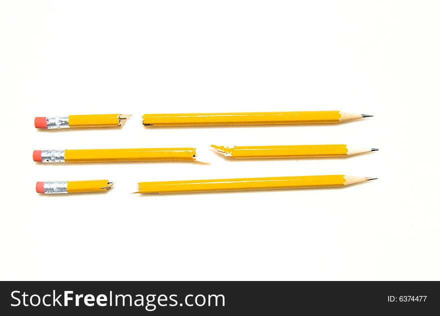 3 Broken Yellow No. 2 Pencils Lined Up In A Row Isolated on White