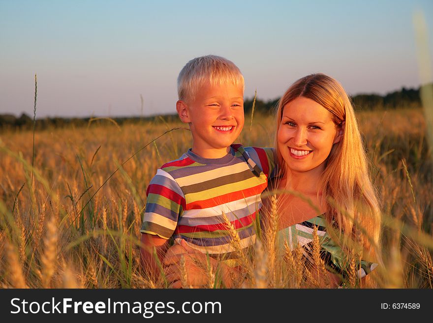 Mother And Son  Sit On Wheaten Field