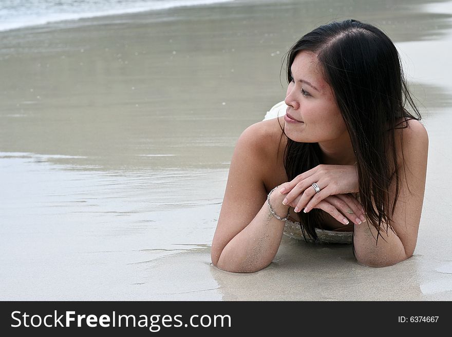 Beautiful Asian woman relaxing on the beach.