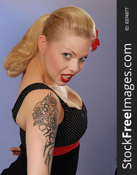 Portrait of cute blond pinup girl with tattoo. Portrait of cute blond pinup girl with tattoo