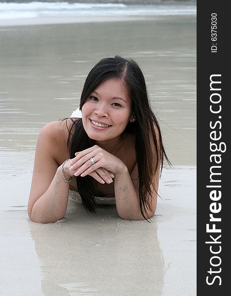 Beautiful Asian woman relaxing on the beach.