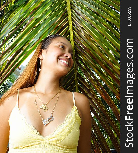 Smiling latina woman in a tropical scene