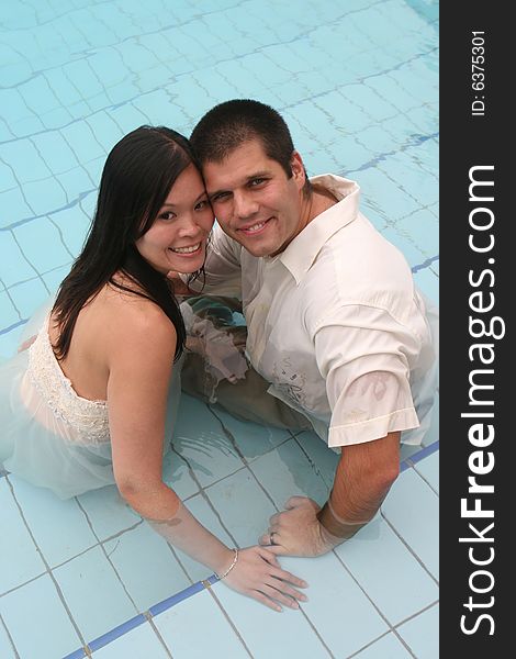 Happy couple in the swimming pool.