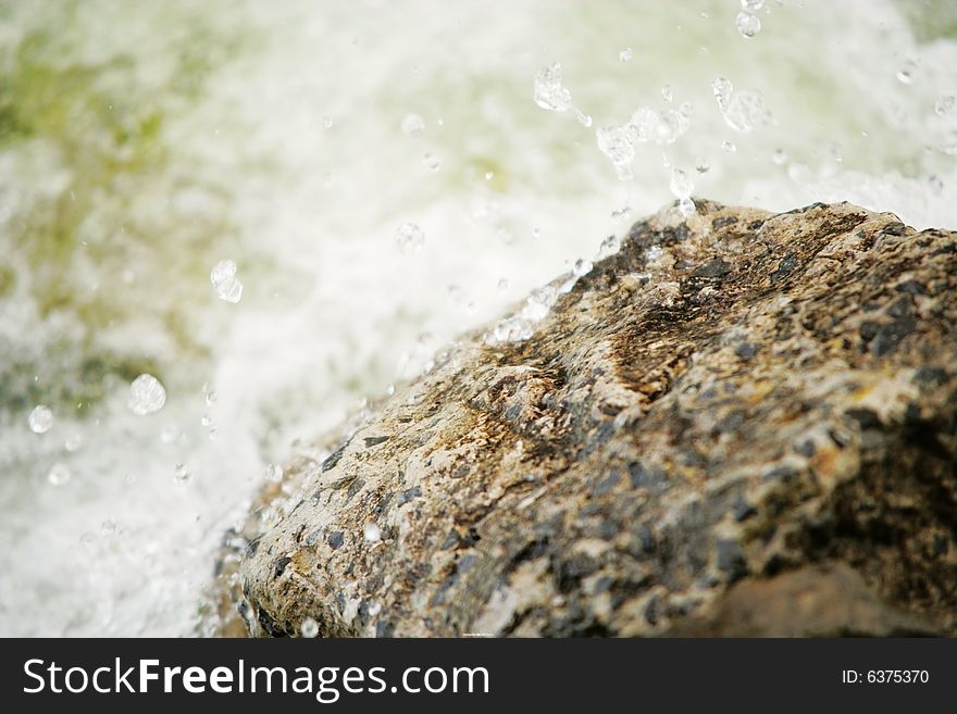 Water hit the rock. Drops. Water hit the rock. Drops