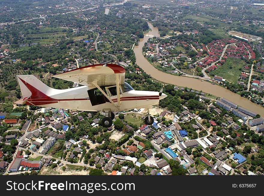 Small airplane flying on a city