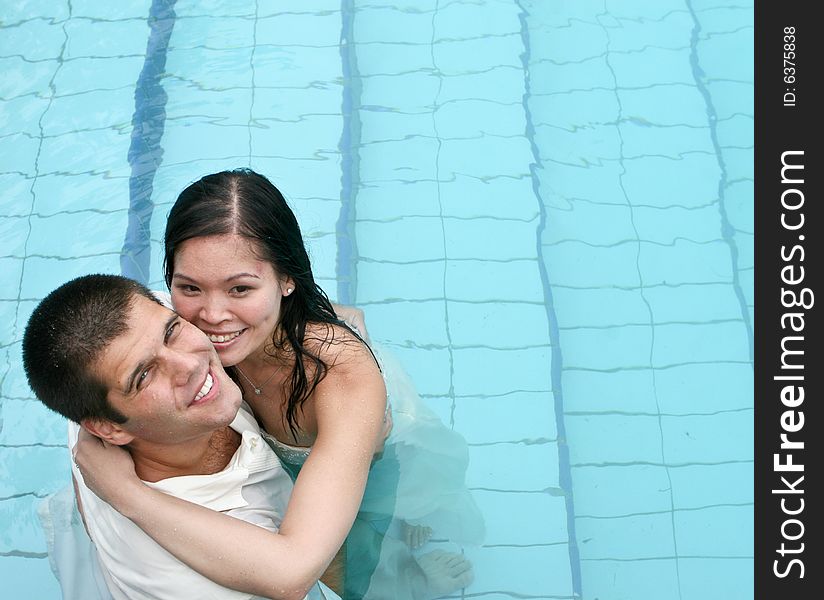 Happy couple in the swimming pool.