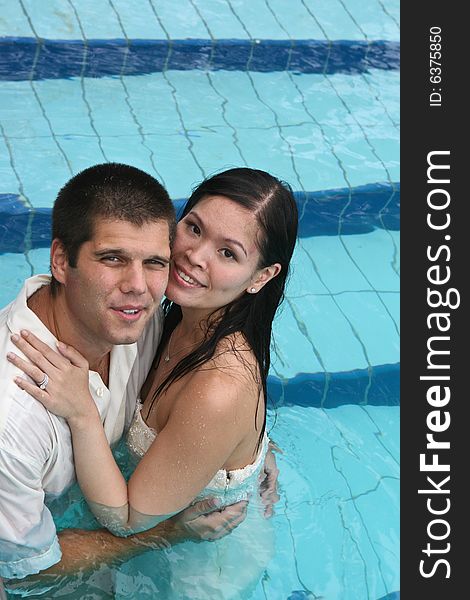 Happy couple in the swimming pool.