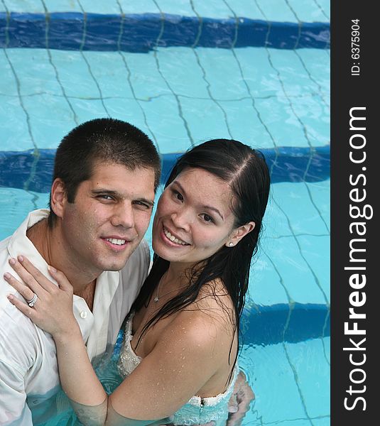 Happy couple in the swimming pool.