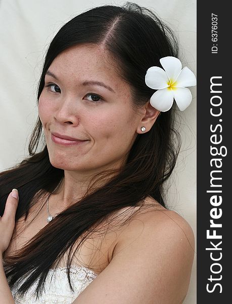 Beautiful Asian bride with a flower in her hair. Beautiful Asian bride with a flower in her hair.