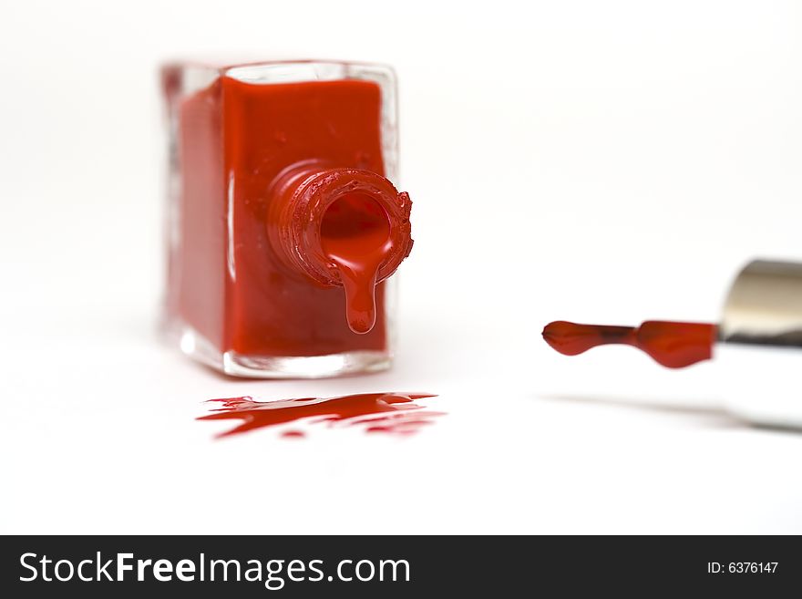 Red, spilling nailpolish isolated on white. Red, spilling nailpolish isolated on white
