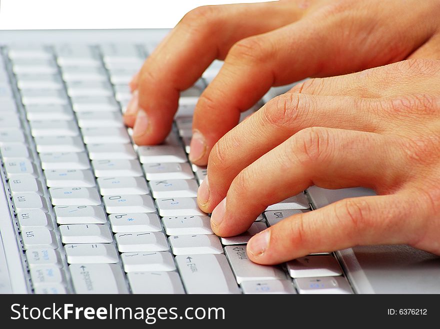 Male hands typing on a laptop
