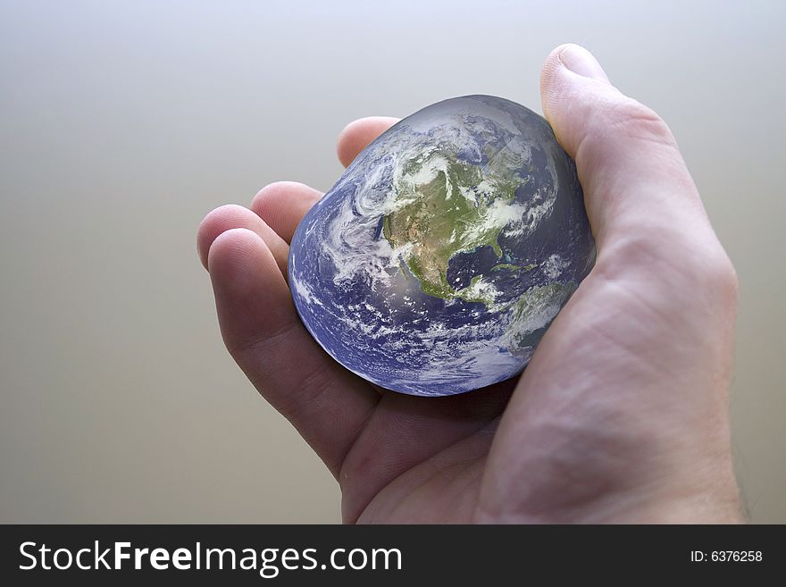 Apple in a hand with world texture. Apple in a hand with world texture