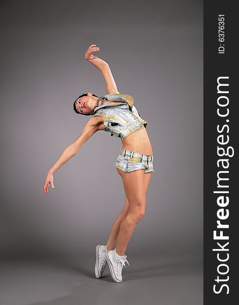 Dancing young woman in the shorts