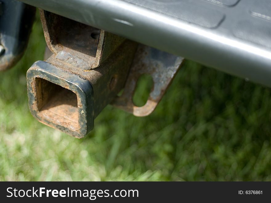 Rusty trailer hook attached to vehicle. Rusty trailer hook attached to vehicle