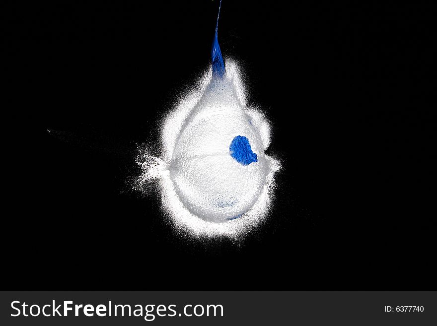 Balloon with water frozen in the moment when the bullet is flying out of it. Balloon with water frozen in the moment when the bullet is flying out of it