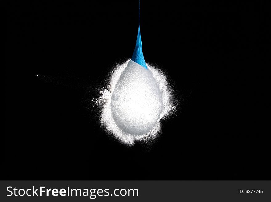 Balloon with water frozen in the moment when the bullet is flying out of it. Balloon with water frozen in the moment when the bullet is flying out of it