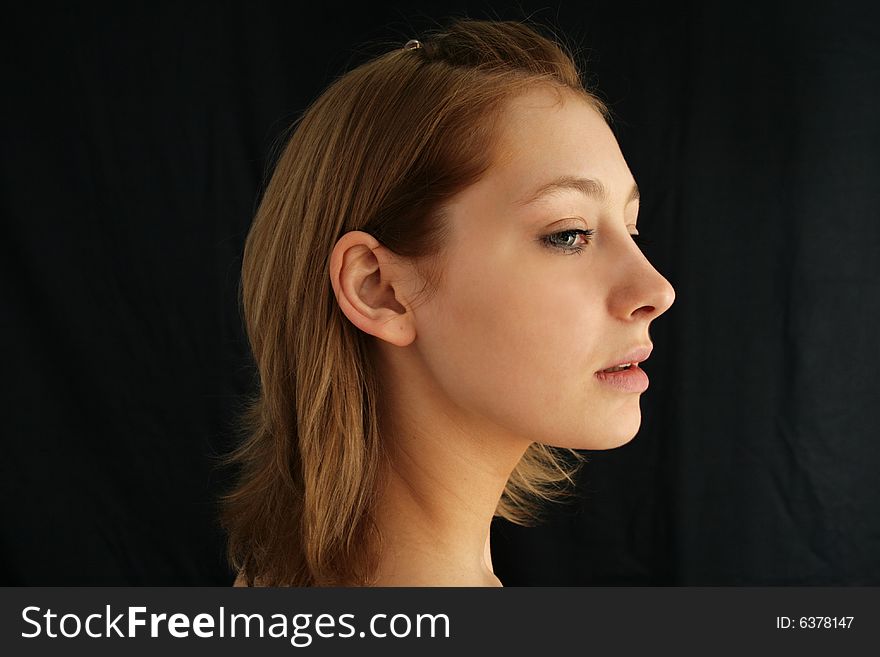 Pretty blonde woman on dark background