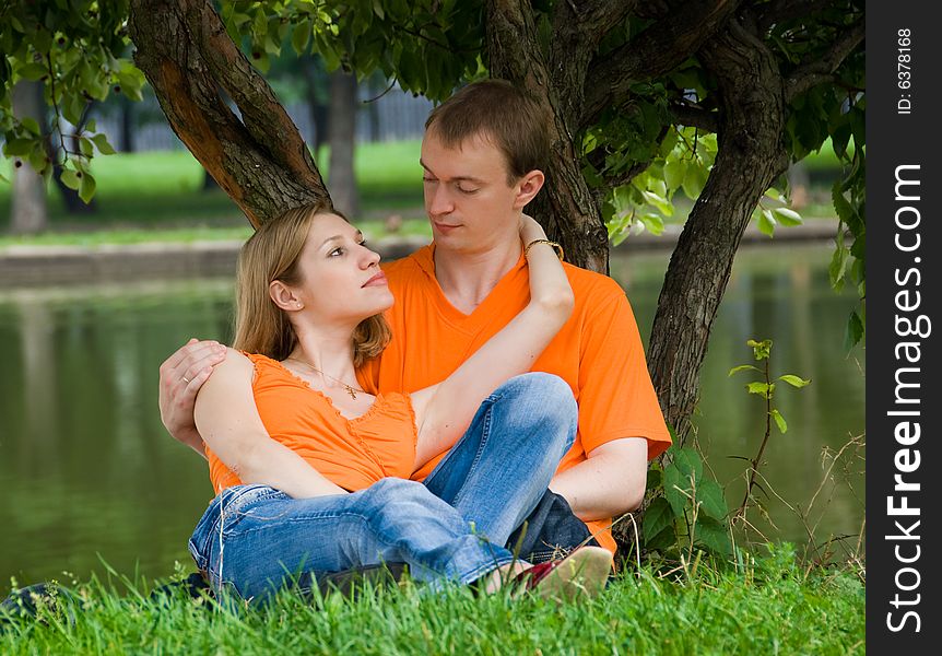 Loving couple has a rest under a tree