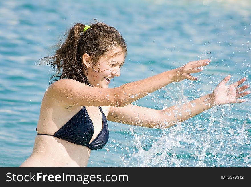 Younger girl reposing on sea by summer