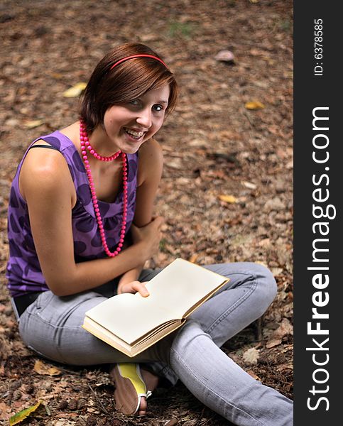 A picture of a girl holding a book in hands. A picture of a girl holding a book in hands