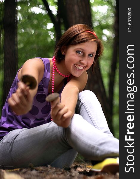 A picture of a girl holding a mushroom in hands. A picture of a girl holding a mushroom in hands