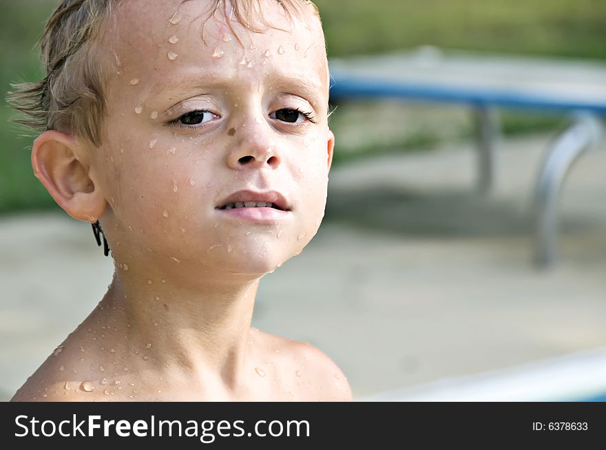 Young boy still dripping with water after swimming in the pool. Young boy still dripping with water after swimming in the pool.