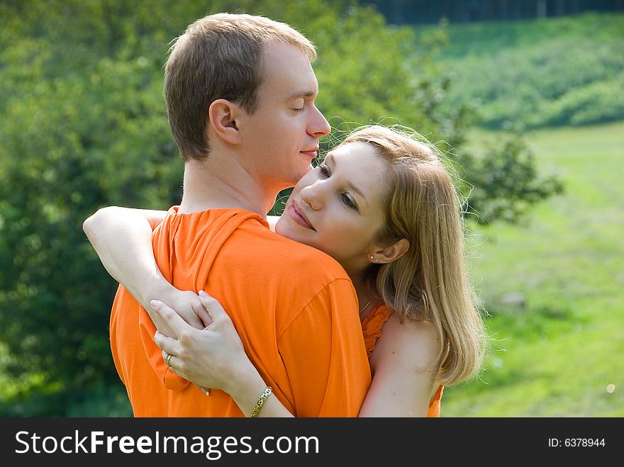 Loving couple embraces on a summer nature