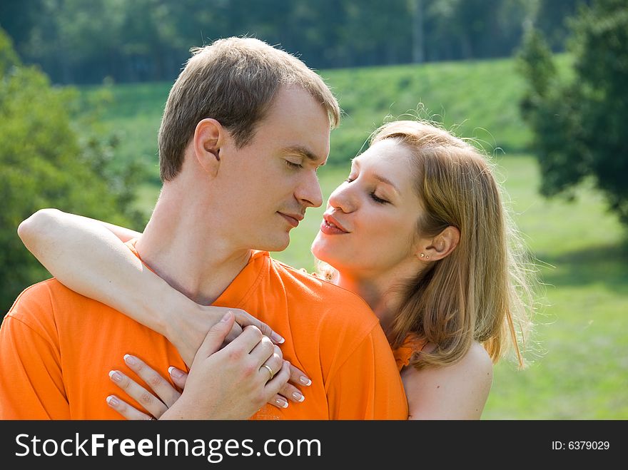 Loving couple embraces on a summer nature