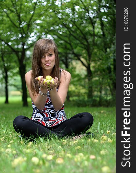 The photo presents young caucasian girl holding some apples in her hands.
The picture was taken in a serene area among the trees. The photo presents young caucasian girl holding some apples in her hands.
The picture was taken in a serene area among the trees.