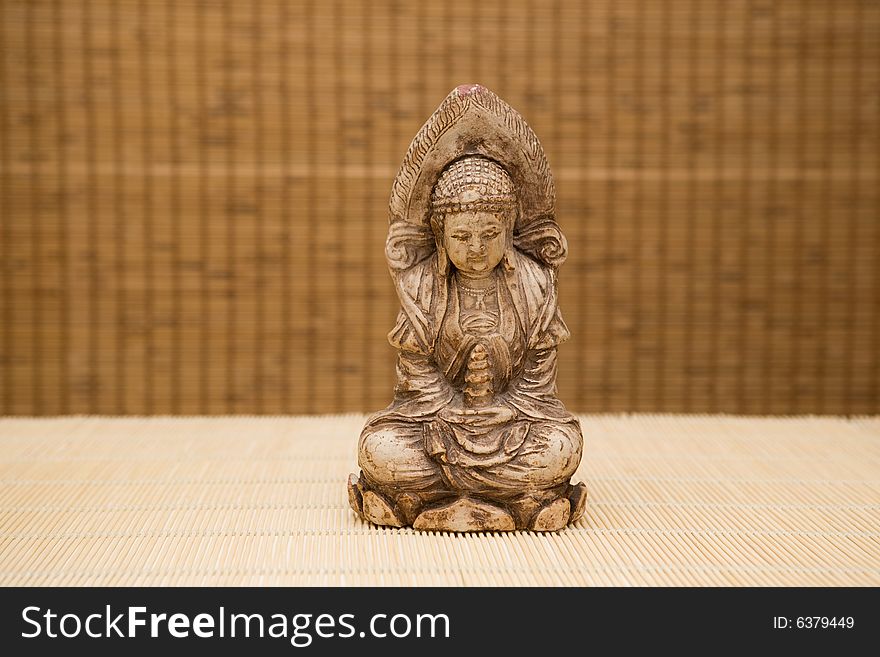 Close up of buddha on bamboo background