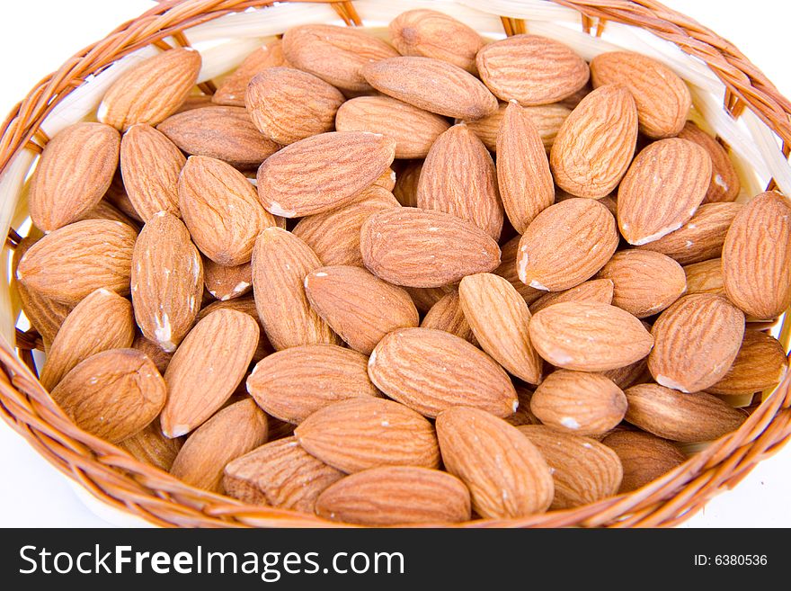 Raw almonds in a bowl - isolated on white. Raw almonds in a bowl - isolated on white