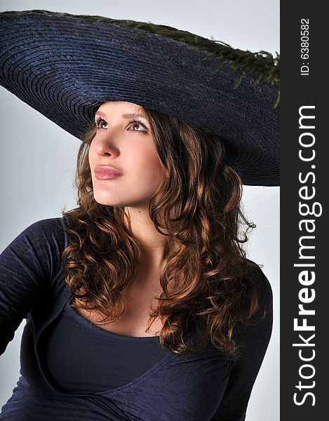 A portrait of beautiful pregnant women is in a hat. A portrait of beautiful pregnant women is in a hat