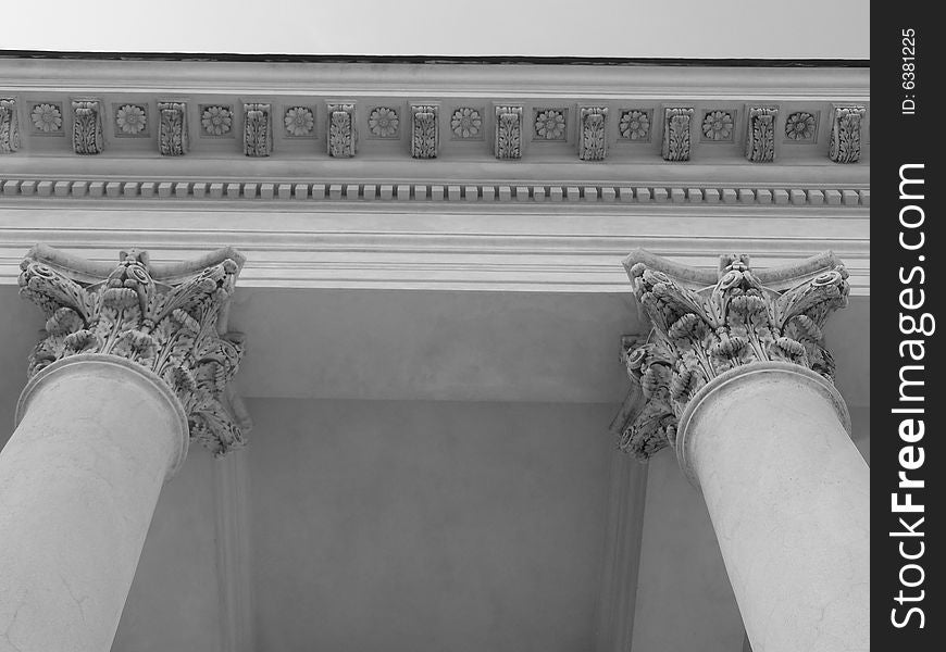 Columns supporting a colonnade in Valtice. Notice the Corinthian style of the head of the column and distinctive flower pattern on a ceiling they support. Columns supporting a colonnade in Valtice. Notice the Corinthian style of the head of the column and distinctive flower pattern on a ceiling they support.