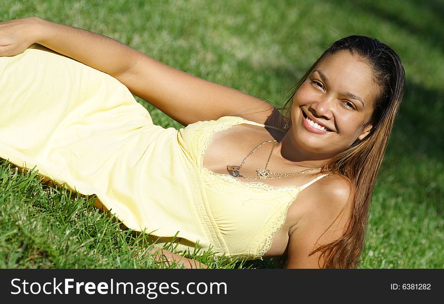 Young smiling woman laying on the grass. Young smiling woman laying on the grass