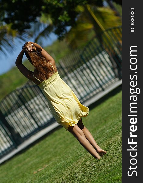 Woman walking away in a park scene