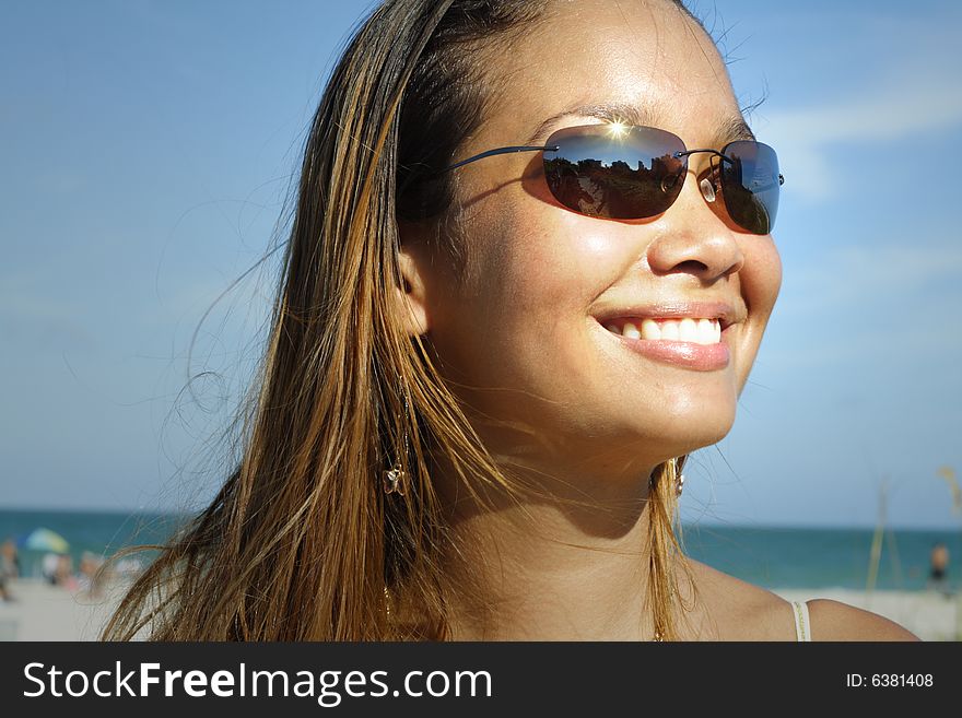 Image of a young woman smiling on a blue sky. Image of a young woman smiling on a blue sky