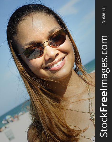 Image of a young woman smiling on a blue sky. Image of a young woman smiling on a blue sky