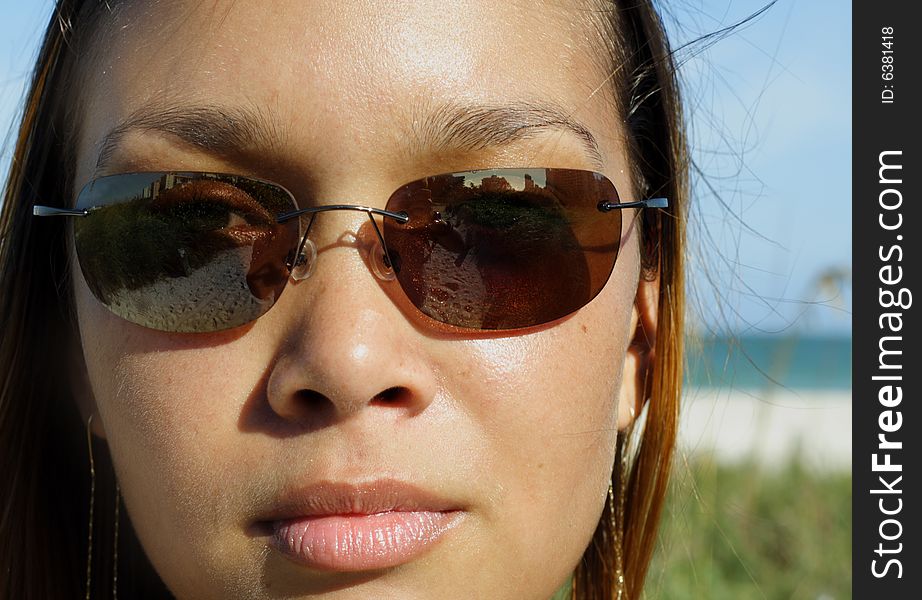 Beautiful young female wearing stylish sunglasses. Beautiful young female wearing stylish sunglasses