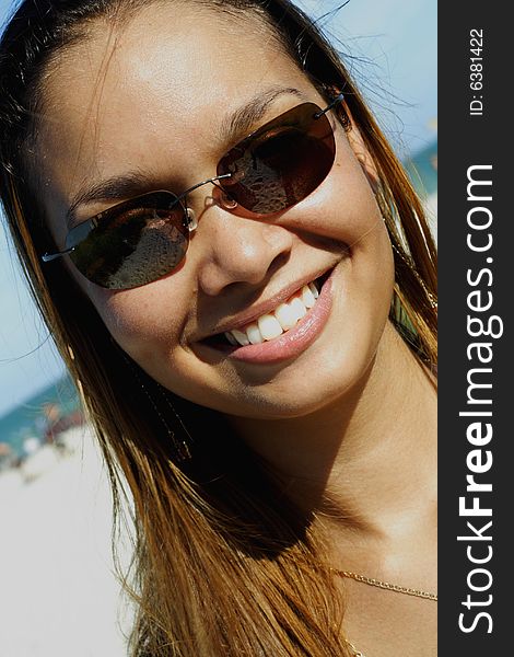 Image of a young woman smiling on a blue sky. Image of a young woman smiling on a blue sky