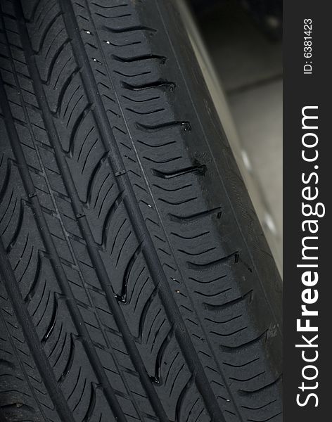 Closeup of a black car tire's tread. Closeup of a black car tire's tread