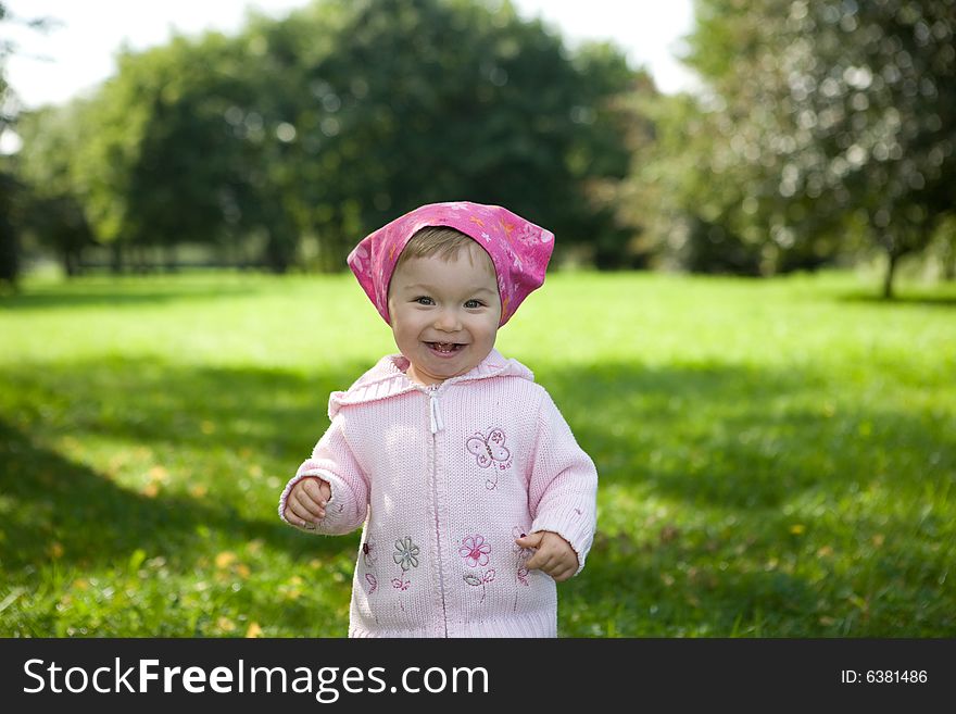 Happy baby girl in park. Happy baby girl in park