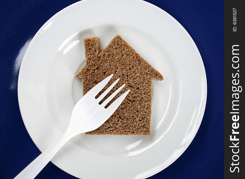 The silhouette of the house from bread lays on a plate. The silhouette of the house from bread lays on a plate.