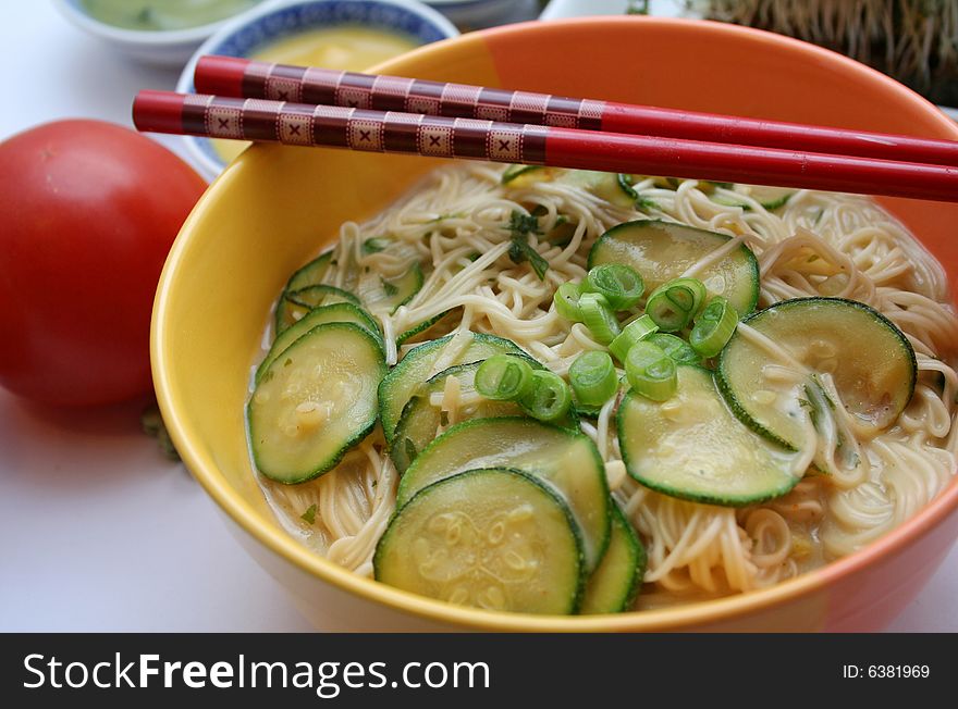 A fresh asian soup with zucchini and noodles. A fresh asian soup with zucchini and noodles