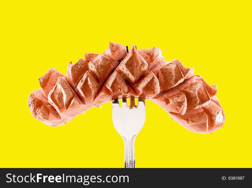 A grilled sausage speared with a fork