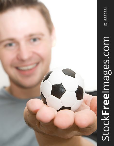 Soccer, football player holding a small ball, ball in focus. Soccer, football player holding a small ball, ball in focus