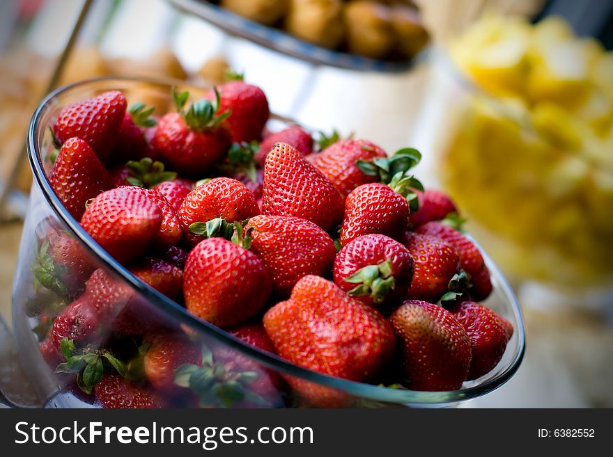 Strawberries served in a glass serving bowl. Strawberries served in a glass serving bowl