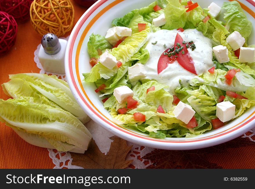 A meal of fresh salad with cheese and tomatoes