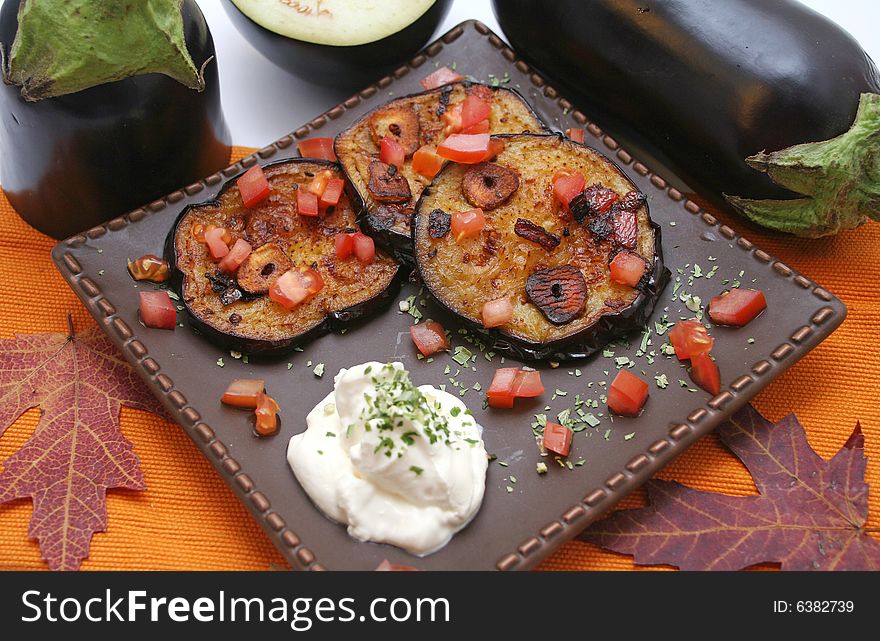 A meal of fresh aubergines, garlic and tomatoes. A meal of fresh aubergines, garlic and tomatoes