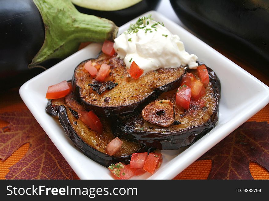 A meal of fresh aubergines, garlic and tomatoes. A meal of fresh aubergines, garlic and tomatoes